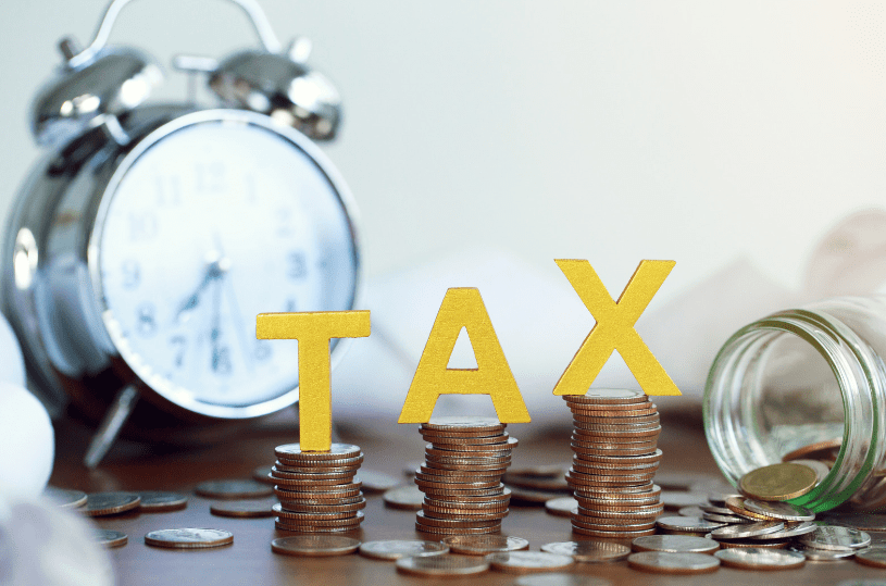 The word tax on stacked coins to remind charities of the specific tax considerations they need to make.